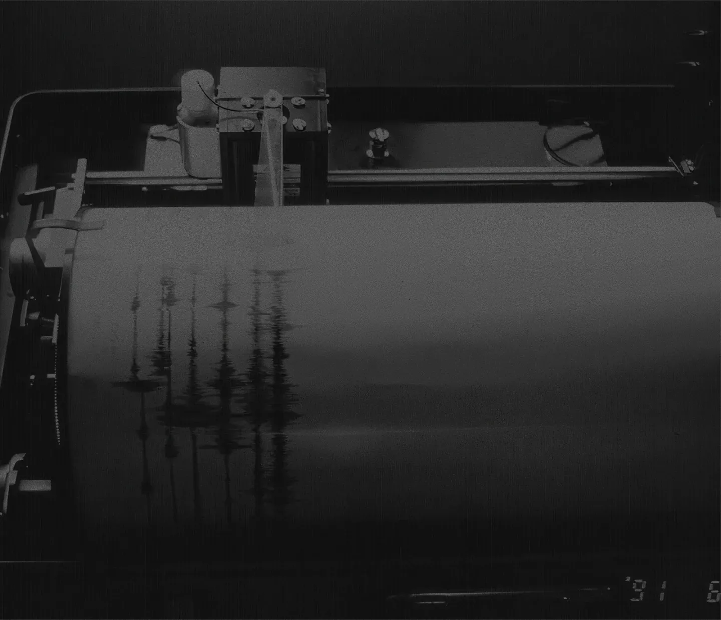 An image of a wave like projection onto a drum of paper